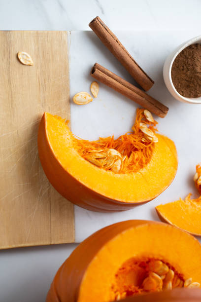 istock pumpkins with cinnamon sticks on marble backgrund 1183893998