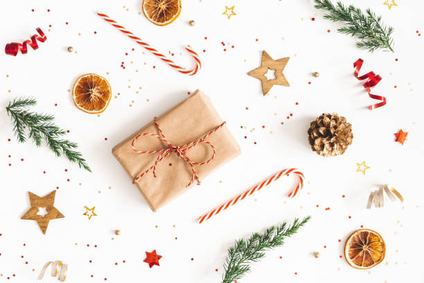 istock Christmas composition. Gift box, fir tree branches, golden decorations on white background. Christmas, winter, new year concept. Flat lay, top view 1183894318
