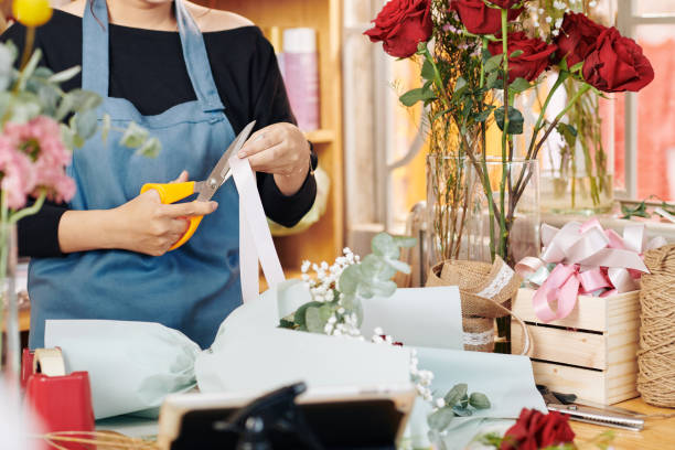 istock Florist cutting decorative ribbon 1183894584