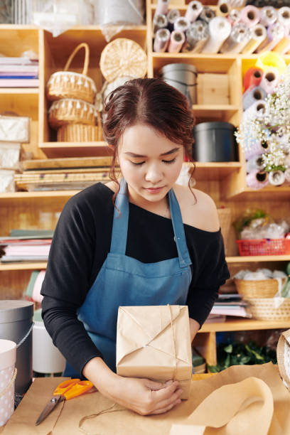 istock Florist concentrated on wrapping present 1183894850