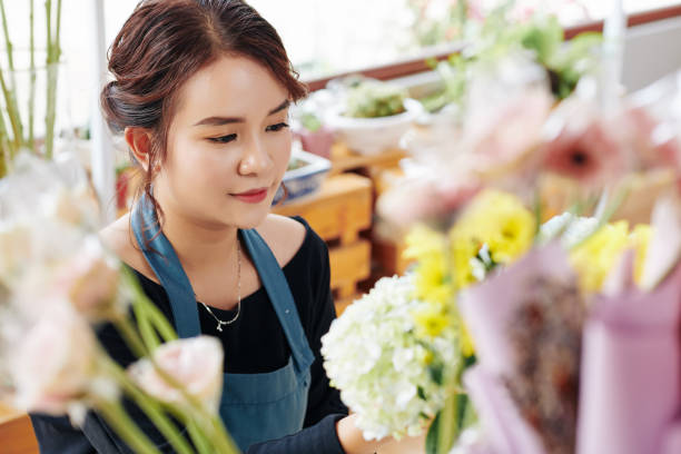 istock Lovely florist working at flower studio 1183895169