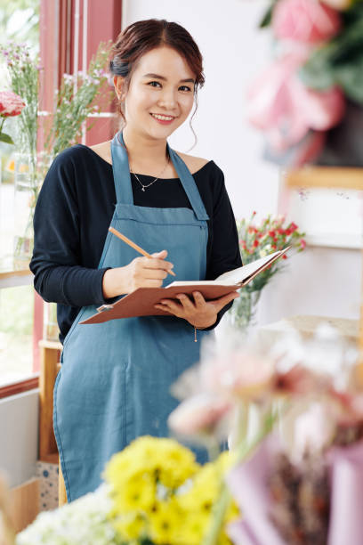 istock Flower shop owner planning work 1183895175