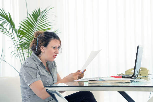 istock business woman reading a document in office workspace 1183895526