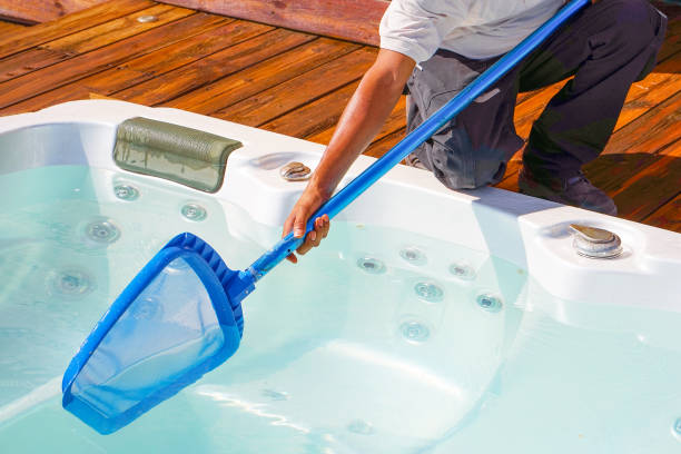 istock Hotel staff worker cleaning the pool. Maintenance. 1183895546