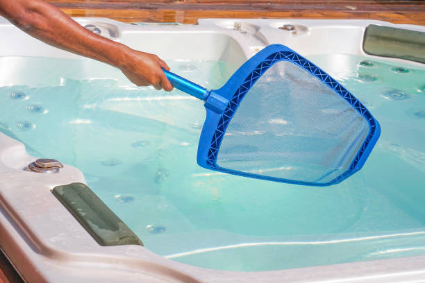 istock Hotel staff worker cleaning the pool. Maintenance. 1183895655
