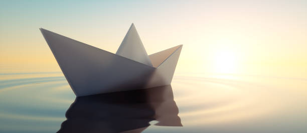 istock Paper boat at Sunset 1183896365