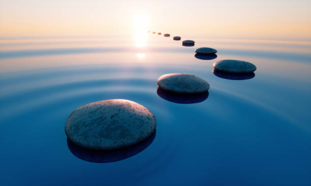Pebbles in wide calm Ocean Row of stones in calm water in the wide ocean concept of meditation - 3D illustration spiritual enlightenment stock pictures, royalty-free photos & images