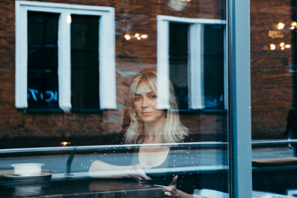 istock Blonde woman in a cafe 1183900373