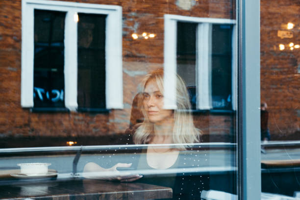 istock Blonde woman in a cafe 1183900379