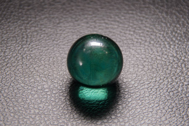 istock glass ball on black leather background 1183901305