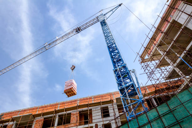 istock Crane is carry pile red blocks packed in plastic foil 1183903960