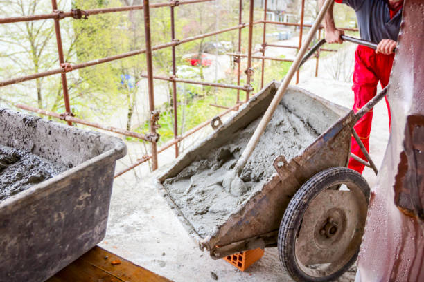 istock Worker is pushing industrial tipping wheelbarrow 1183904707