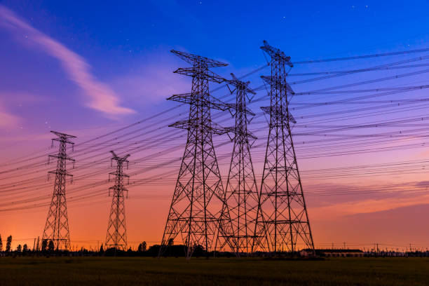 istock High voltage tower silhouette and sky landscape at dusk 1183904714