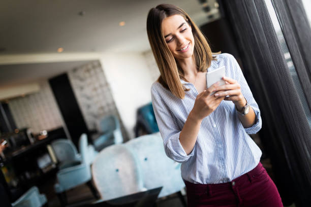 istock Young brunette lady touching and browsing her smart phone 1183904754