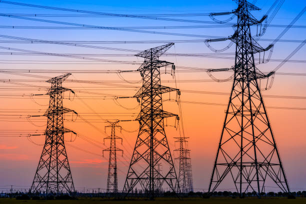 istock High voltage tower silhouette and sky landscape at dusk 1183904848