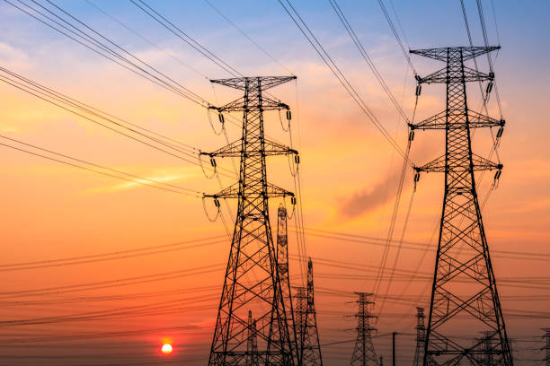 istock High voltage tower silhouette and sky landscape at dusk 1183905405