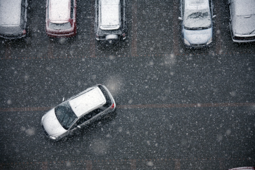 elevated view of parking lot during snow.