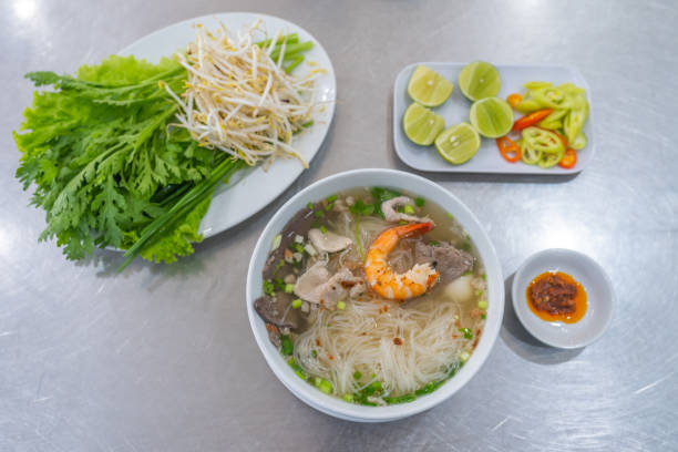 istock Vietnamese rice noodle soup and shrimp served with vegetables 1183909890
