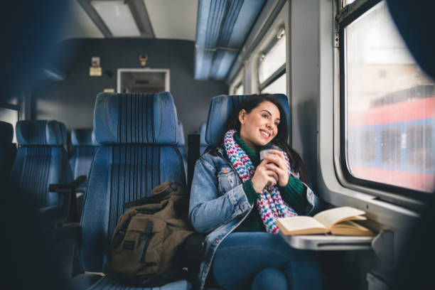 istock Women reading book on the train 1183910531