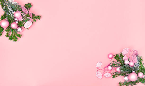 istock Christmas ornament decoration pine tree branches pink background 1183911283