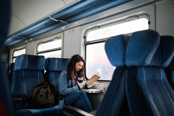 istock Women reading book on the train 1183911695