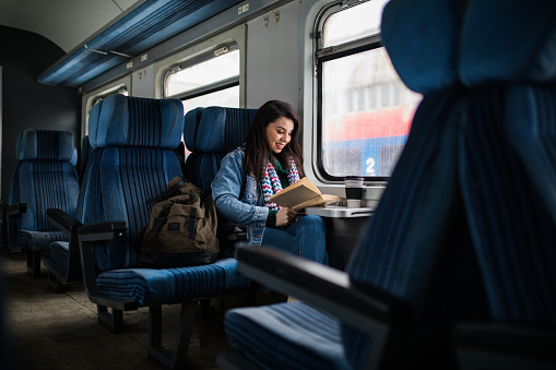 Women reading book on the train