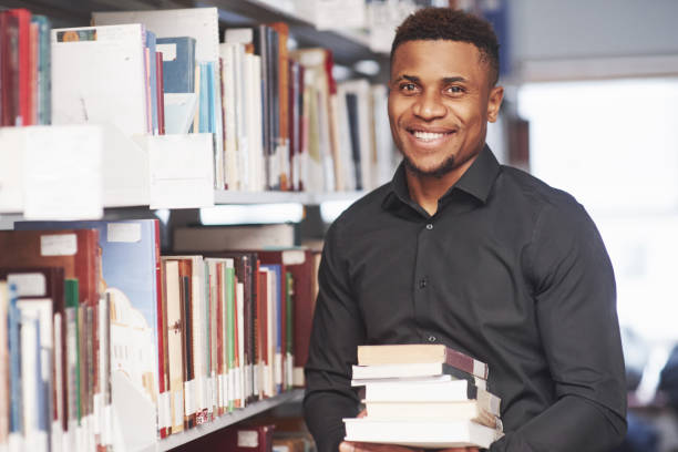 istock Ready for study. African american man in the library searching for some information in the books 1183914190