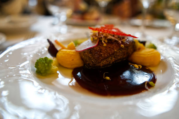 main course in the restaurant. The food is nicely laid on a white plate with a delicate pattern. mouth-watering dish and beautiful play of colors.