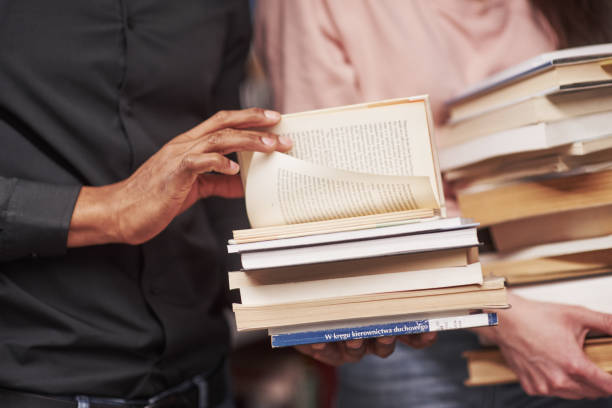 istock Conception of education. Multiracial students in the library searching for the information together 1183916146