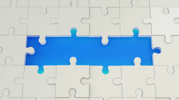 istock Jigsaw puzzle where the middle four puzzle is missing revealing a blue background 1183916634