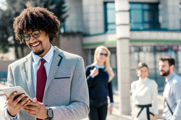 istock Portrait of successful businessman using tablet 1183917795