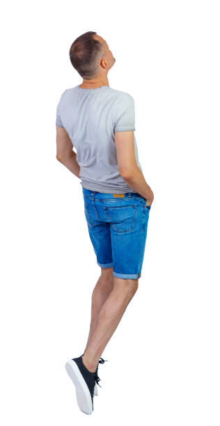 istock Back view of a man dancing in shorts. 1183918490