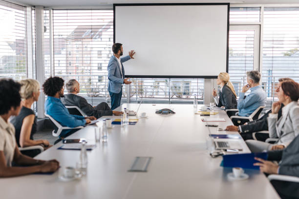 istock CEO giving a business presentation through projection screen in a board room. 1183920277