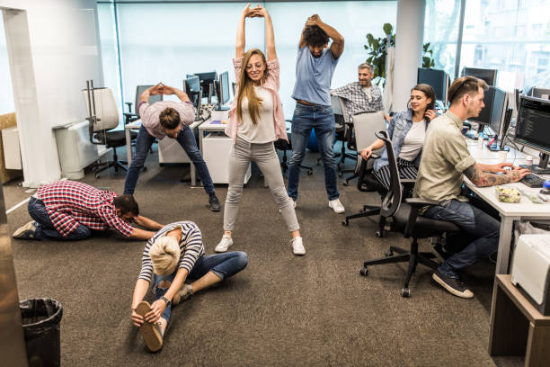 istock Group of programmers exercising on a break in the office. 1183921195