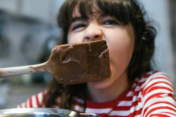 istock tasting the sweet brownie dough 1183921416