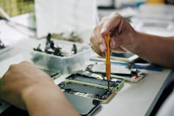 istock Repairman removing smartphone battery 1183922207