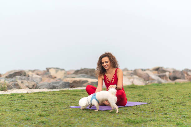 Woman doing yoga with her dog