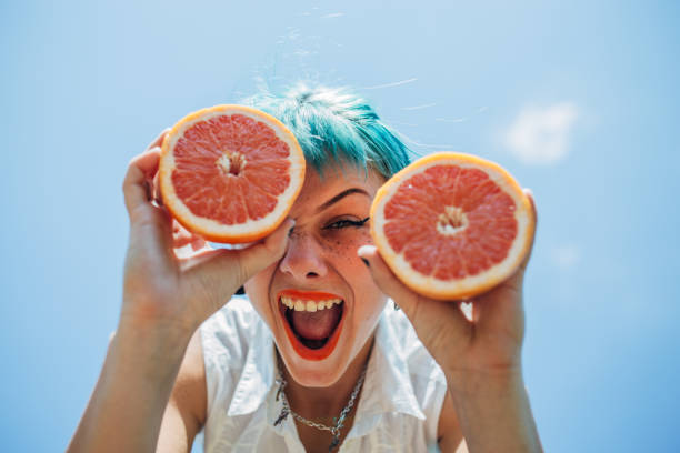istock Young woman with orange 1183925320