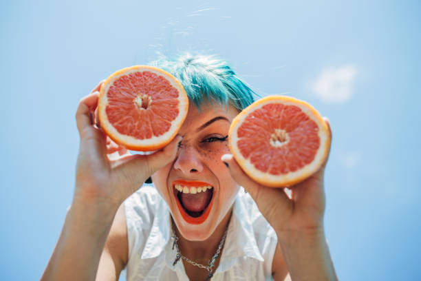 istock Young woman with orange 1183925340