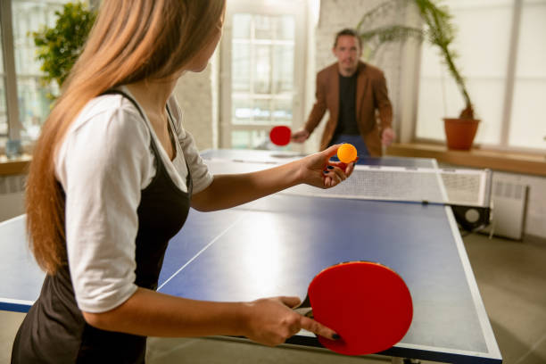 istock Young people playing table tennis in workplace, having fun 1183925936