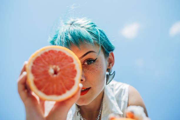 istock Young woman with orange 1183926578