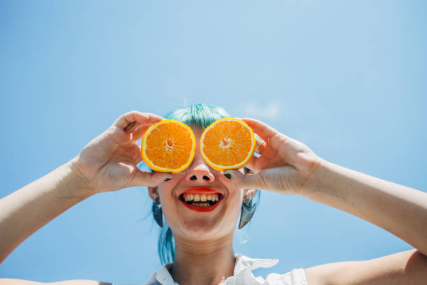 istock Young woman with orange 1183926703