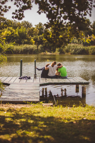 istock Woman hugging her children on a pier 1183927108