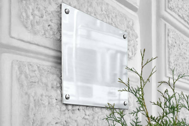 istock Blank silver glass signboard on gray textured wall mock up 1183927616
