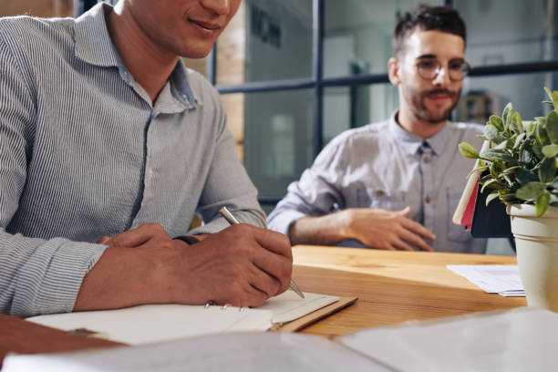 istock Businessman writing in planner 1183927705