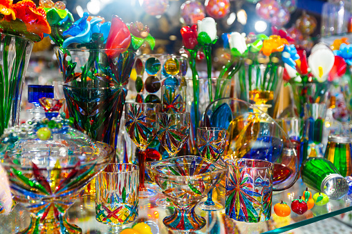 Colorful souvenirs from famous Murano glass on showcase of gift shop in Venice