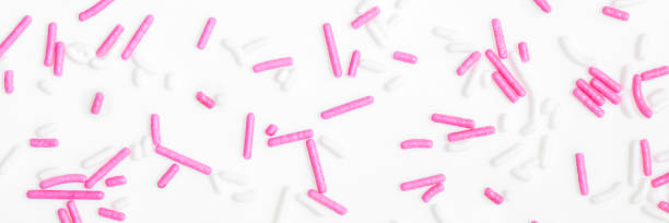 istock Banner, white and pink sugar sprinkles spreading on white background 1183929113