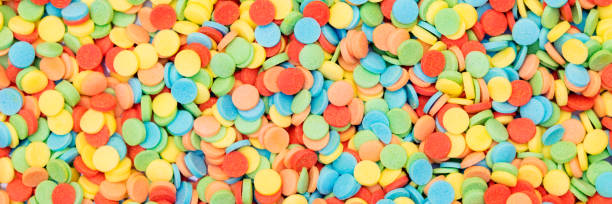 istock Banner with round candy sprinkles or sugar confetti, party background 1183929255