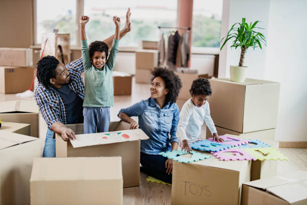 istock Happy African American family having fun while moving into new home. 1183929366