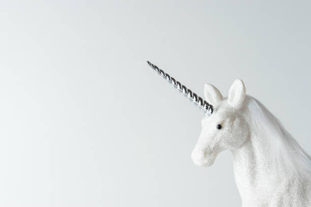istock Creative composition with glitter unicorn on white background. Minimal holiday concept. 1183931805